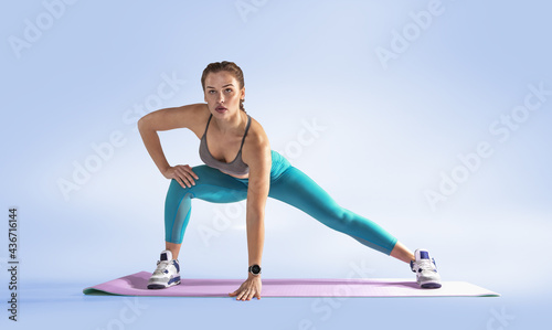 Sports. Beautiful woman at the gym doing fitness exercises.