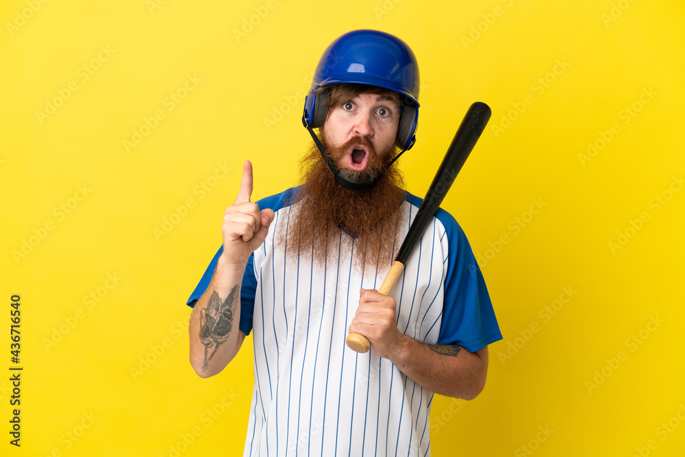 Redhead baseball player man with helmet and bat isolated on yellow background intending to realizes the solution while lifting a finger up