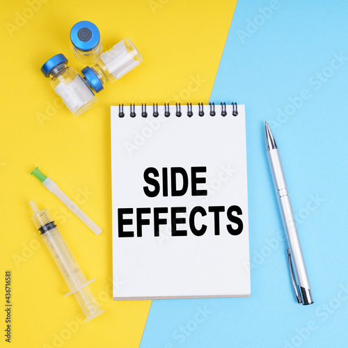 A syringe, ampoules and a notebook with the inscription - Side effects photo