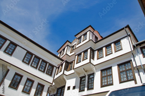 Abandoned white old house vintage style with wooden windows on clear blue sky