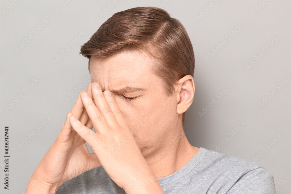 Portrait of mature man touching face with hands, trying to concentrate Portrait of mature man touching face with hands, trying to concentrate