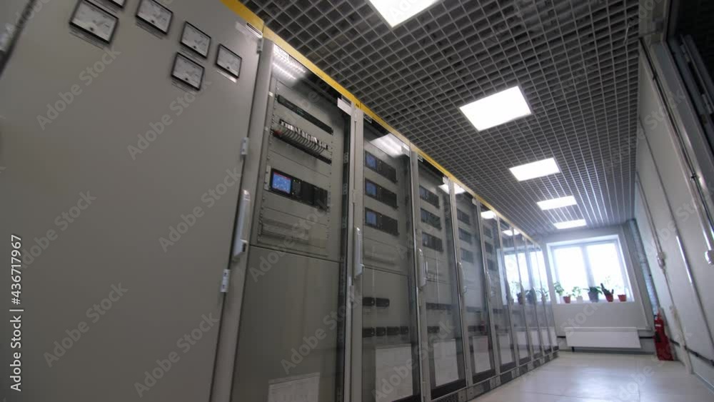 Row of cabinets with different switch gears and buttons in modern electricity production substation control premises
