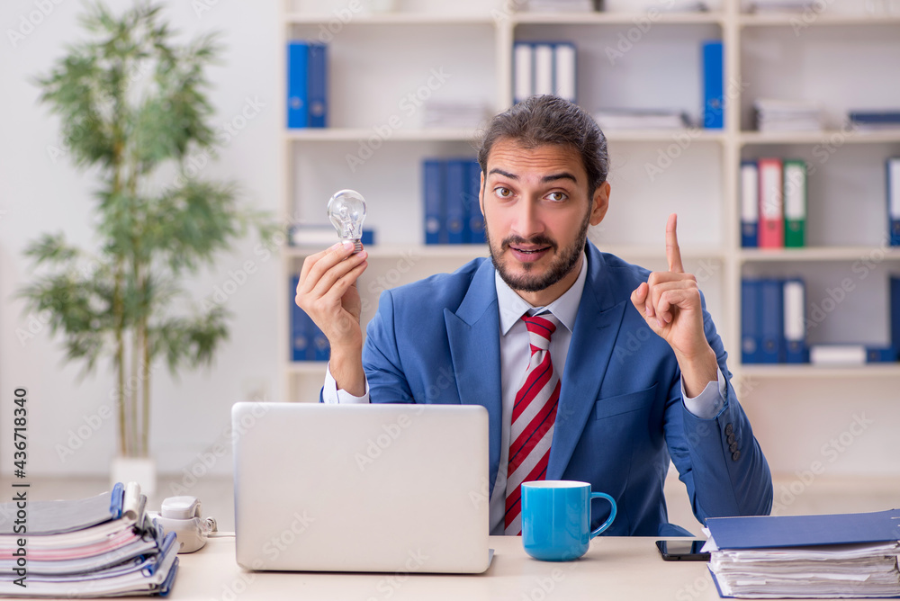 Young male employee working in the office Young male employee working in the office