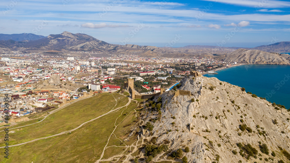 Mountain fortress (Genoese Fortress). Genoese Fortress is located in Sudak, Coast of the Crimea peninsula, rocky mountains, aerial view of the sea resort Sudak