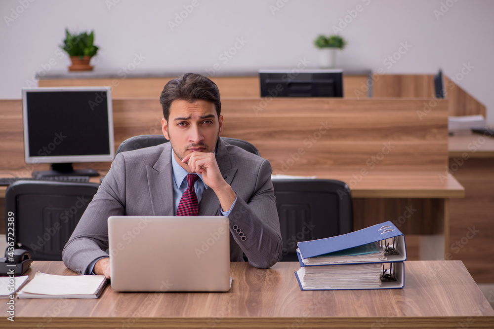 Young businessman employee working in the office Young businessman employee working in the office