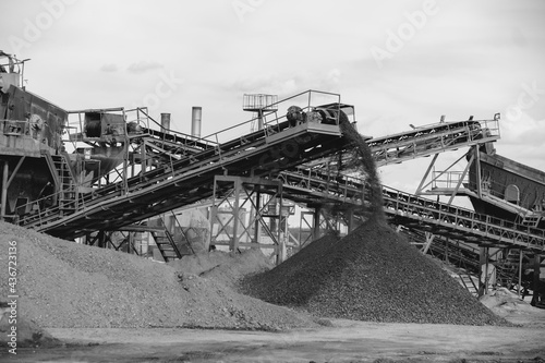 Industrial background - crusher (rock stone crushing machine) at open pit mining and processing plant for crushed stone, sand and gravel photo