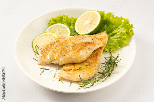 Pan-fried chicken breast on a solid background