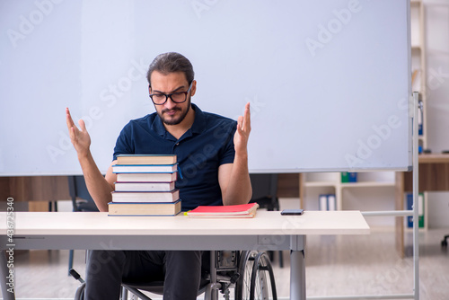 Young male handicapped student in the classroom