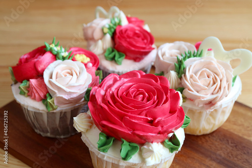 Closeup a set of gorgeous rose shaped frosting cupcakes with selective focus