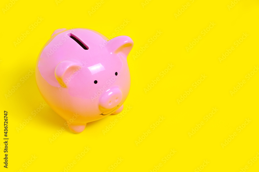 Pink Piggy Bank on Yellow Background