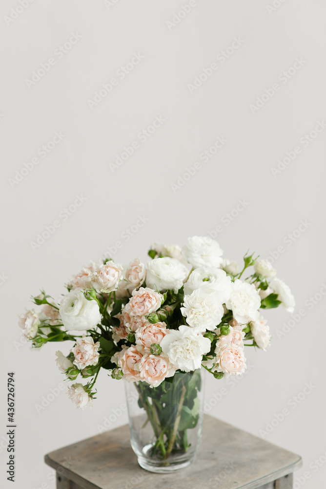 bouquet of flowers in a vase on a wooden table on a white solid background bouquet of flowers in a vase on a wooden table on a white solid background