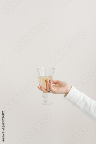 faceted glass glass in the hands of a girl in white clothes glass