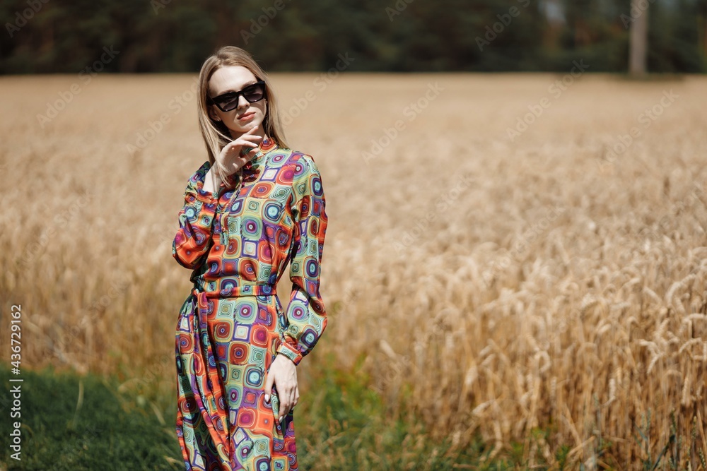 A beautiful young woman is walking in a wheat field A beautiful young woman is walking in a wheat field
