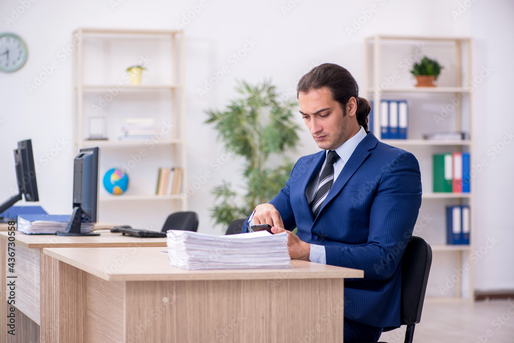Young male employee working in the office Young male employee working in the office