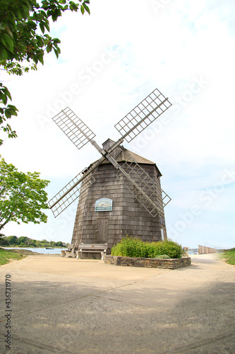 Old wooden windmill near the ocean in the summer