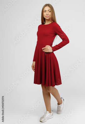 Gorgeous woman. Portrait of beautiful smiling young woman standing in cute red dress isolated on white background in full length. the concept of advertising dresses for the store © Дмитрий Скорина