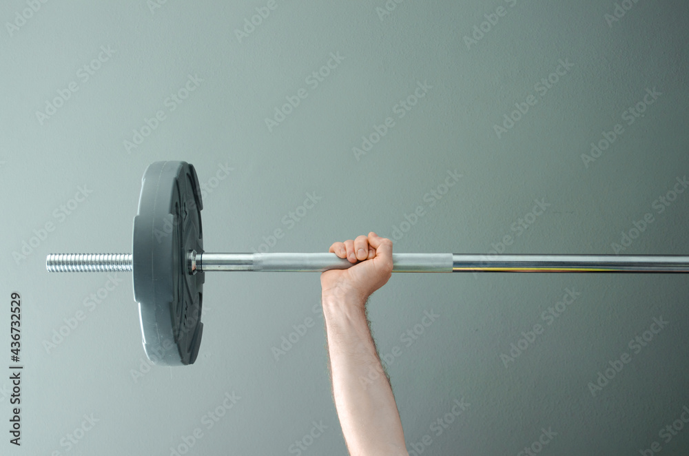 Photo of muscular mixed race man workout with barbell in home gym Photo of muscular mixed race man workout with barbell in home gym