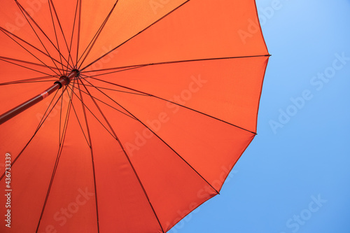 orange parasol under blue sky
