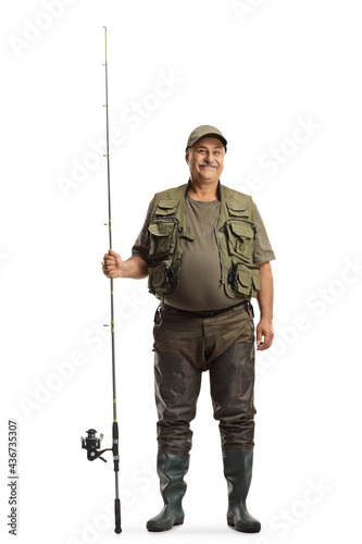 Full length portrait of a mature fisherman in a uniform standing with a fishing rod
