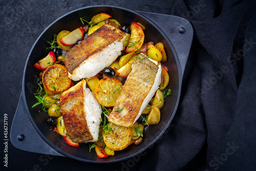Canvas Print Modern style traditional fried skrei cod fish filet with fried potato, fruits an