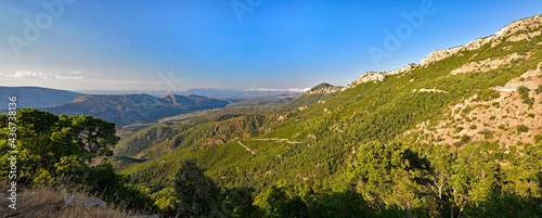 Panoramic Mountain Landscape with layered by blue sky over the mountain ranges, Sardinia, Orosei region. © gadzius