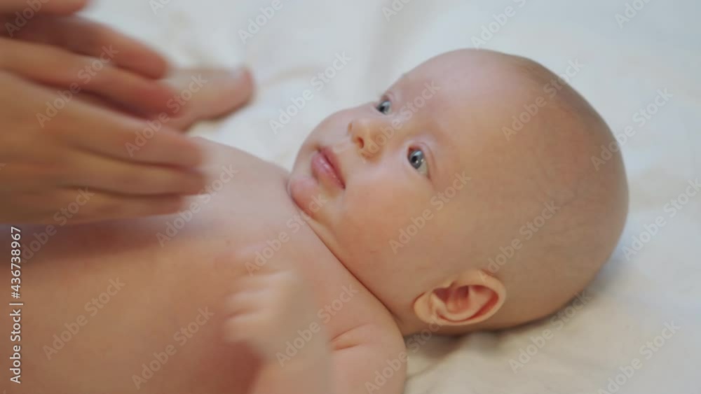 Mother massage 3 months old baby boy gently ppressing, rubbing parts of infant body, relax baby. High quality 4k footage Mother massage 3 months old baby boy gently ppressing, rubbing parts of infant body, relax baby. High quality 4k footage