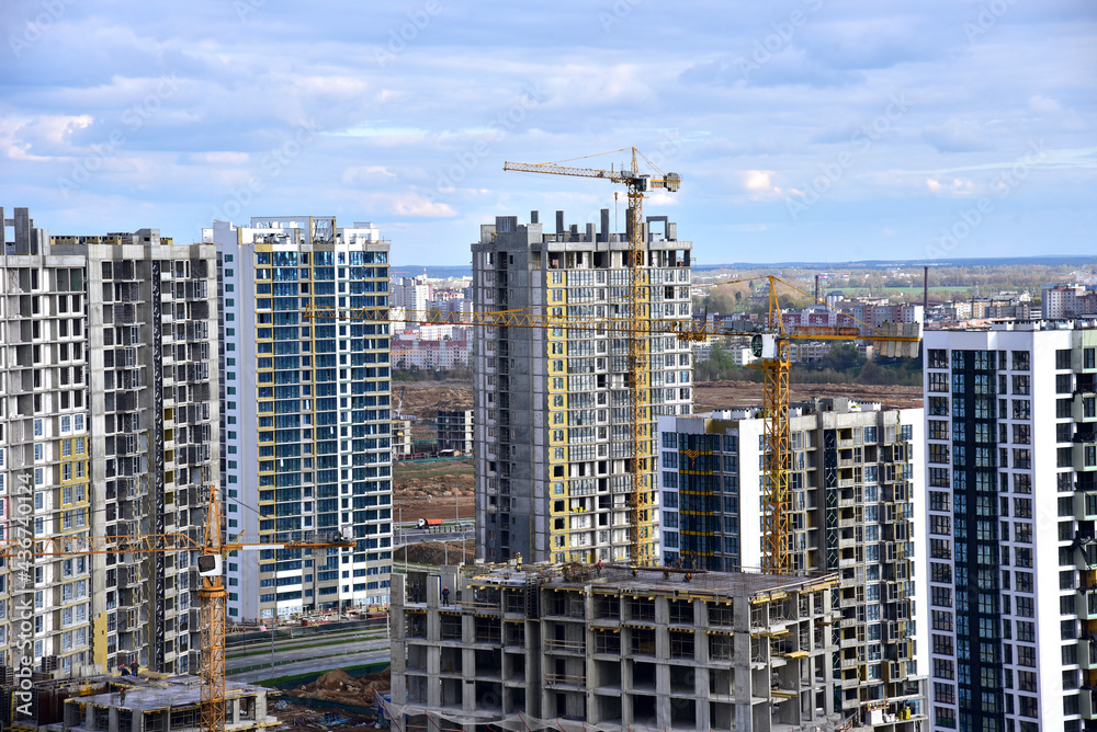 Tower crane during construction of a residential building. Cranes on formworks. Construction the building or multi-storey homes, Arial view. Renovation concept. Realtor and Real Estate Tower crane during construction of a residential building. Cranes on formworks. Construction the building or multi-storey homes, Arial view. Renovation concept. Realtor and Real Estate