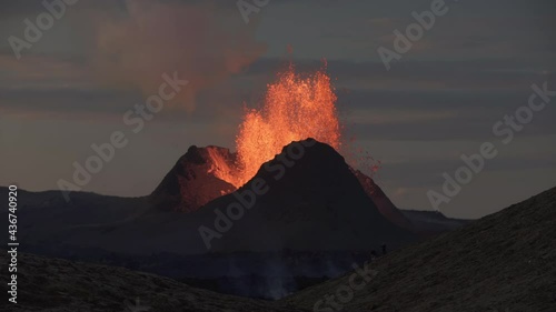 Spectators watching powerful eruption at dusk Iceland