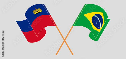 Crossed and waving flags of Liechtenstein and Brazi