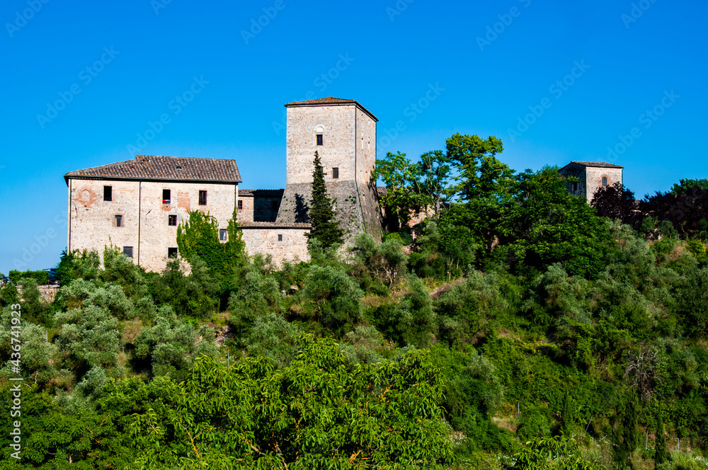 Panoramic view of the Tuscan hills with medieval houses surrounded by blooming nature