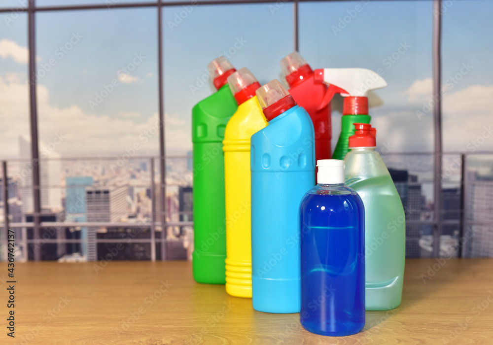 Detergent bottles on the window background. Detergents and laundry household chemicals for cleaning and washing. Housekeeping concept. Liquids for dishwasher.