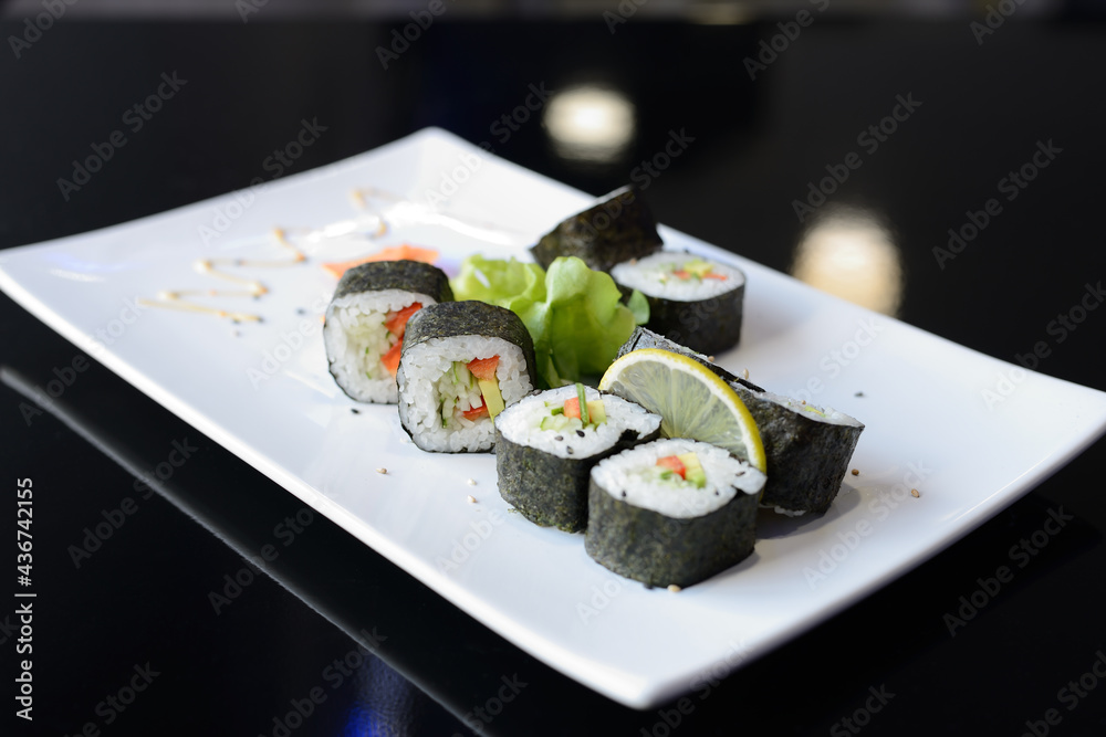 Sushi rolls on white dish. Japanese food. Sushi rolls on white dish. Japanese food.