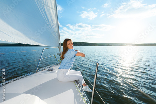 Happy Woman Sitting On Yacht Deck Enjoying Sea Ride Outdoors