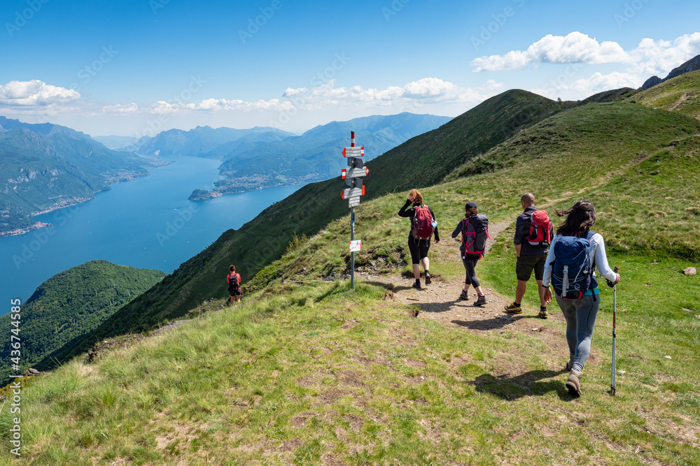 Trekking scene on Lake Como alps (the arrows indicates the names of the locations reached by the trails)