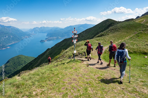 Fototapeta Naklejka Na Ścianę i Meble -  Trekking scene on Lake Como alps (the arrows indicates the names of the locations reached by the trails)