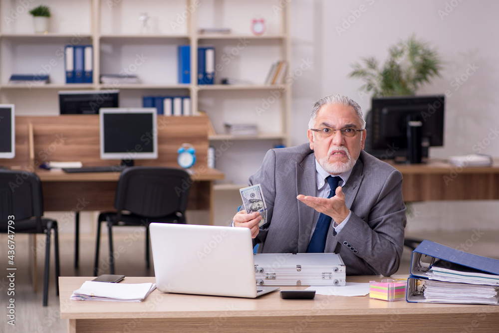 Old male employee in remuneration concept Old male employee in remuneration concept