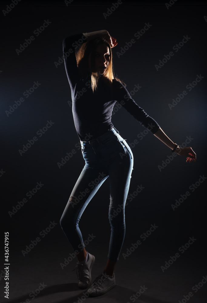 Silhouette picture of a young gorgeous woman posing on black background Silhouette picture of a young gorgeous woman posing on black background