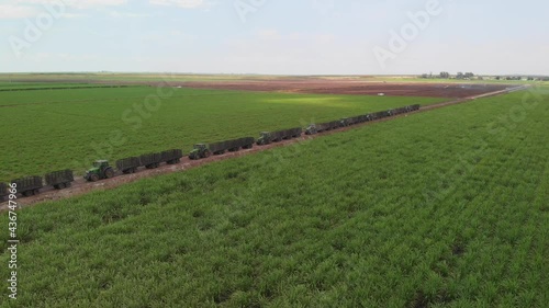Sugar cane fields with tractors in Florida. Aerial view.