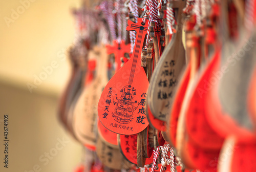 Wooden Ema votive plaques in shape of Japanese Biwa instrument symbol of the godess of the arts and music Benzaiten in the Bentendo hall of Kaneiji temple in Ueno park. photo