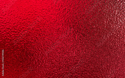 Red shiny foil metallic paper texture background. Use for christmas and valentine day concept.