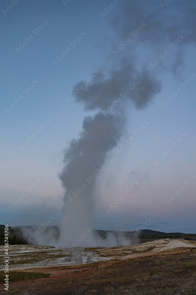 Old Faithful geyser eruption in Yellowstone National Park, Wyoming, USA