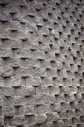 Shot of an unordinary wall made of stone in a form of patterned texture photo