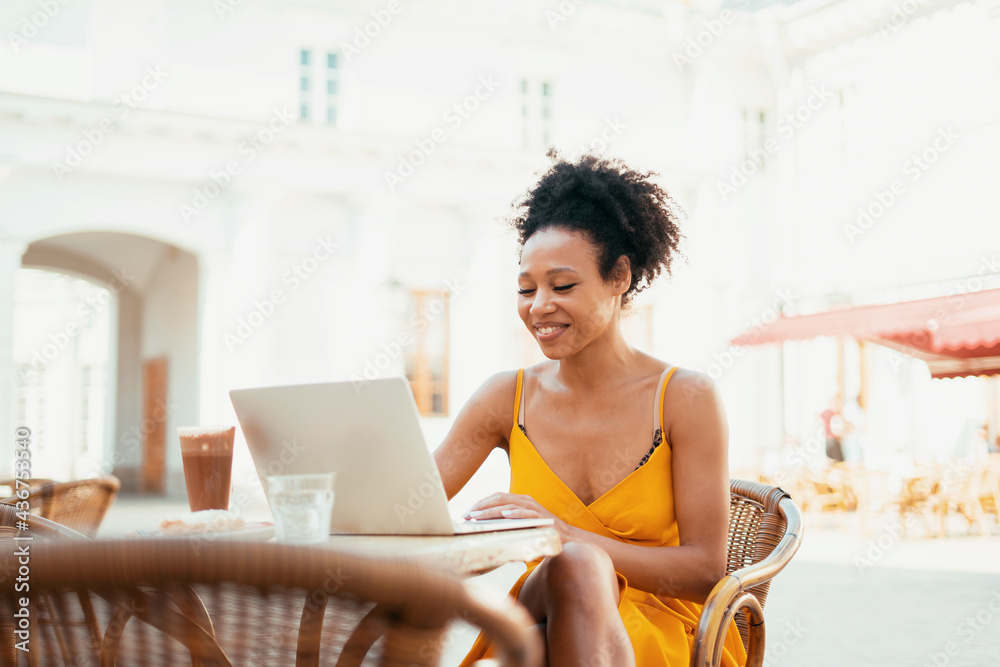 Student learning during a break on a laptop. Sitting in a summer restaurant ordered breakfast before work. Young woman shopping online in a cafe. Student learning during a break on a laptop. Sitting in a summer restaurant ordered breakfast before work. Young woman shopping online in a cafe.