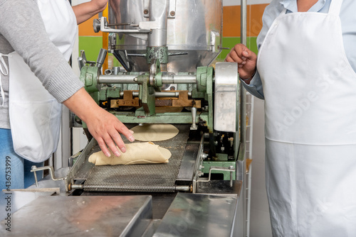machine to make tortillas Mexican tortilleria with metal band and a kilo of tortillas wrapped in white paper