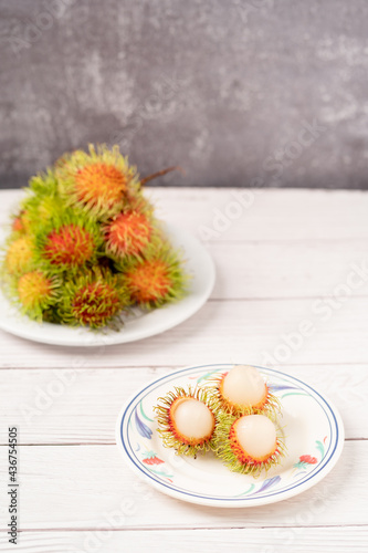 Thailand's fruit rambutan is placed on a wooden table.