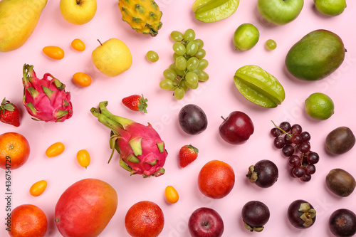 Fototapeta Naklejka Na Ścianę i Meble -  Assortment of fresh exotic fruits on pink background, flat lay