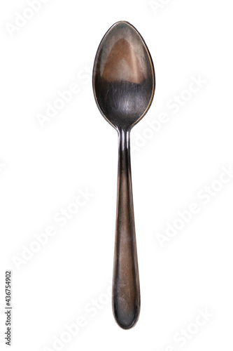 A silver spoon covered with a dark bloom. Old metal cutlery. © Piotr