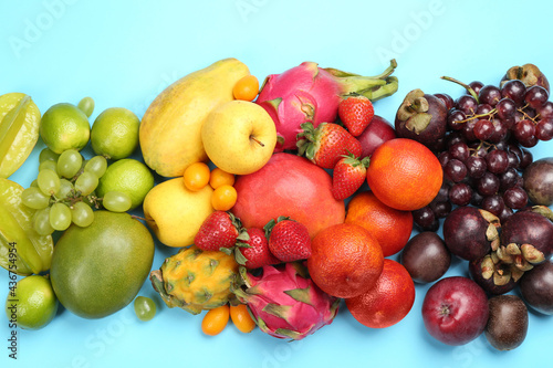 Fototapeta Naklejka Na Ścianę i Meble -  Many different delicious exotic fruits on light blue background, flat lay