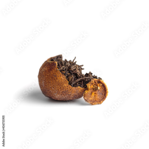 pu-erh tea in half of tangerine with top of tangerine  isolated