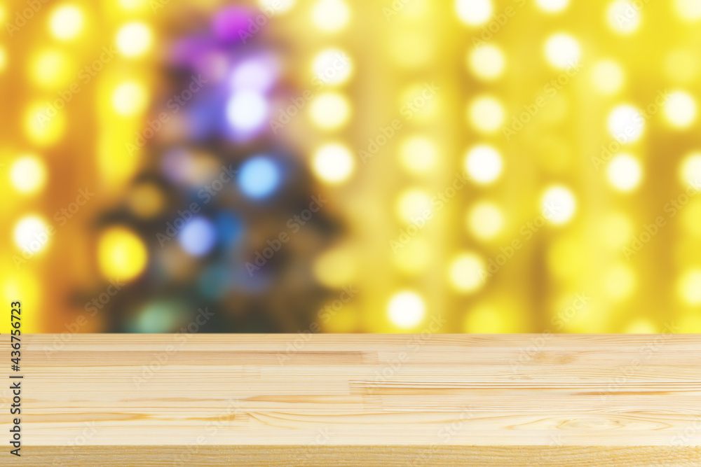 wood table top on blur christmas tree with garlands background wood table top on blur christmas tree with garlands background